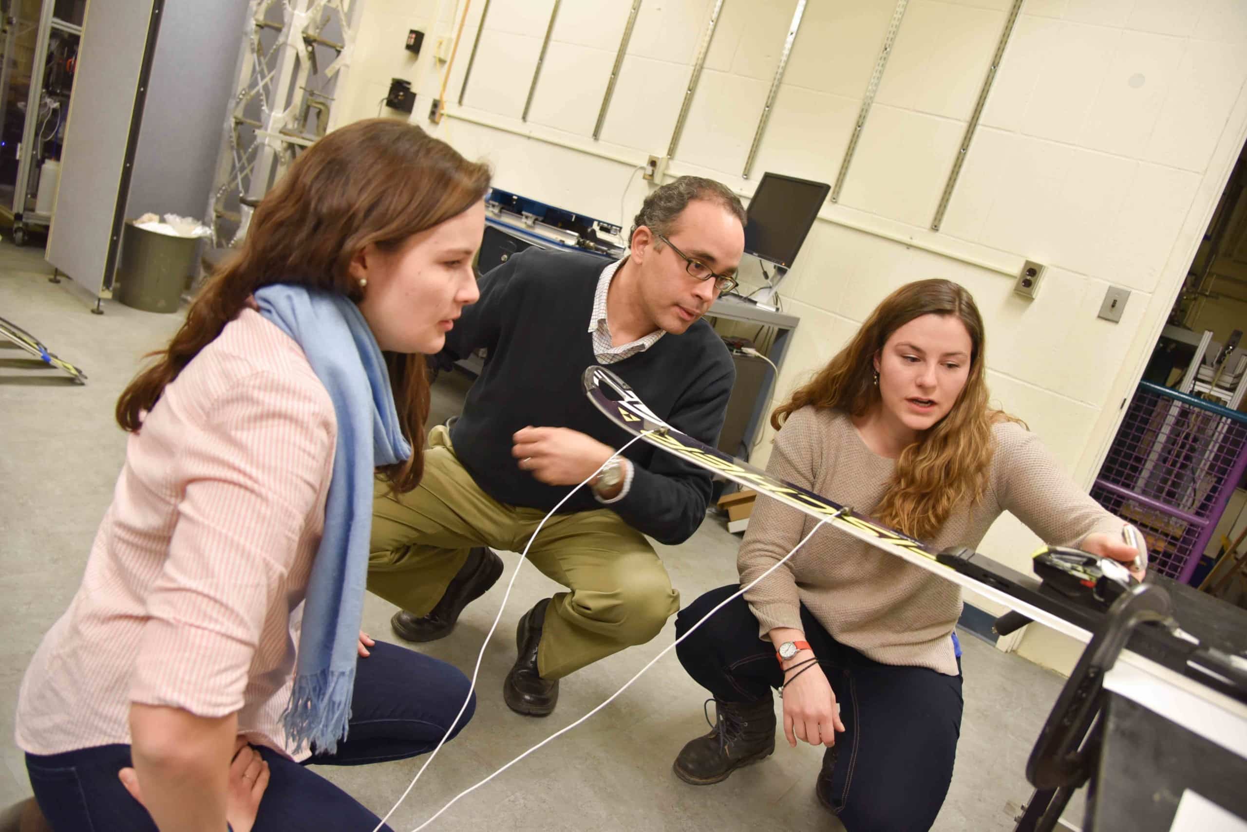 (Left to right) Elizabeth Richards, Professor Eric Hernanzez and Elli Terwiel test the ski's vibration. - Photo by Joshua Brown