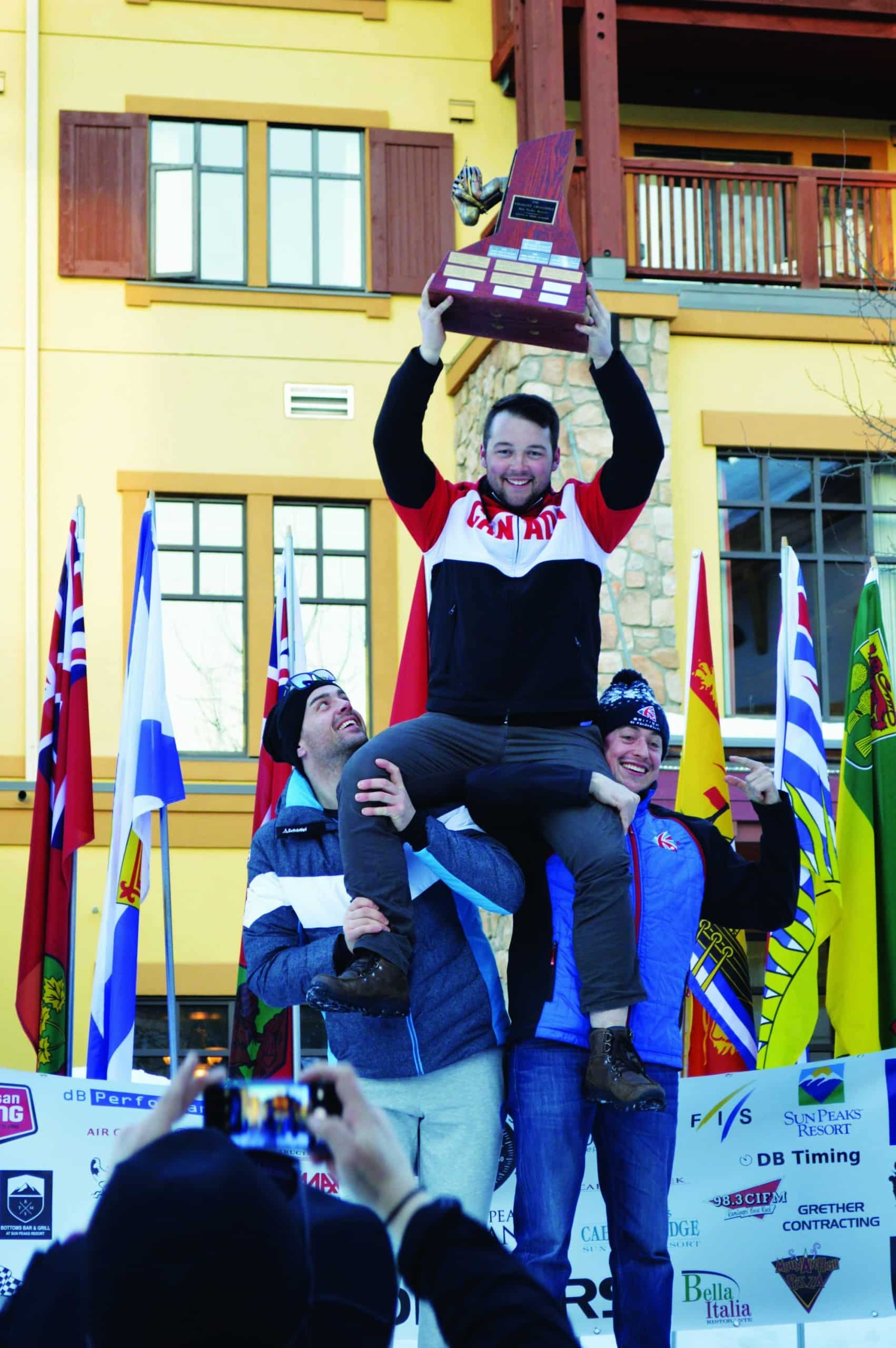 Joss Advocaat lifts the Velocity Challenge trophy on the shoulders of fellow speed skiers. - Photo Submitted
