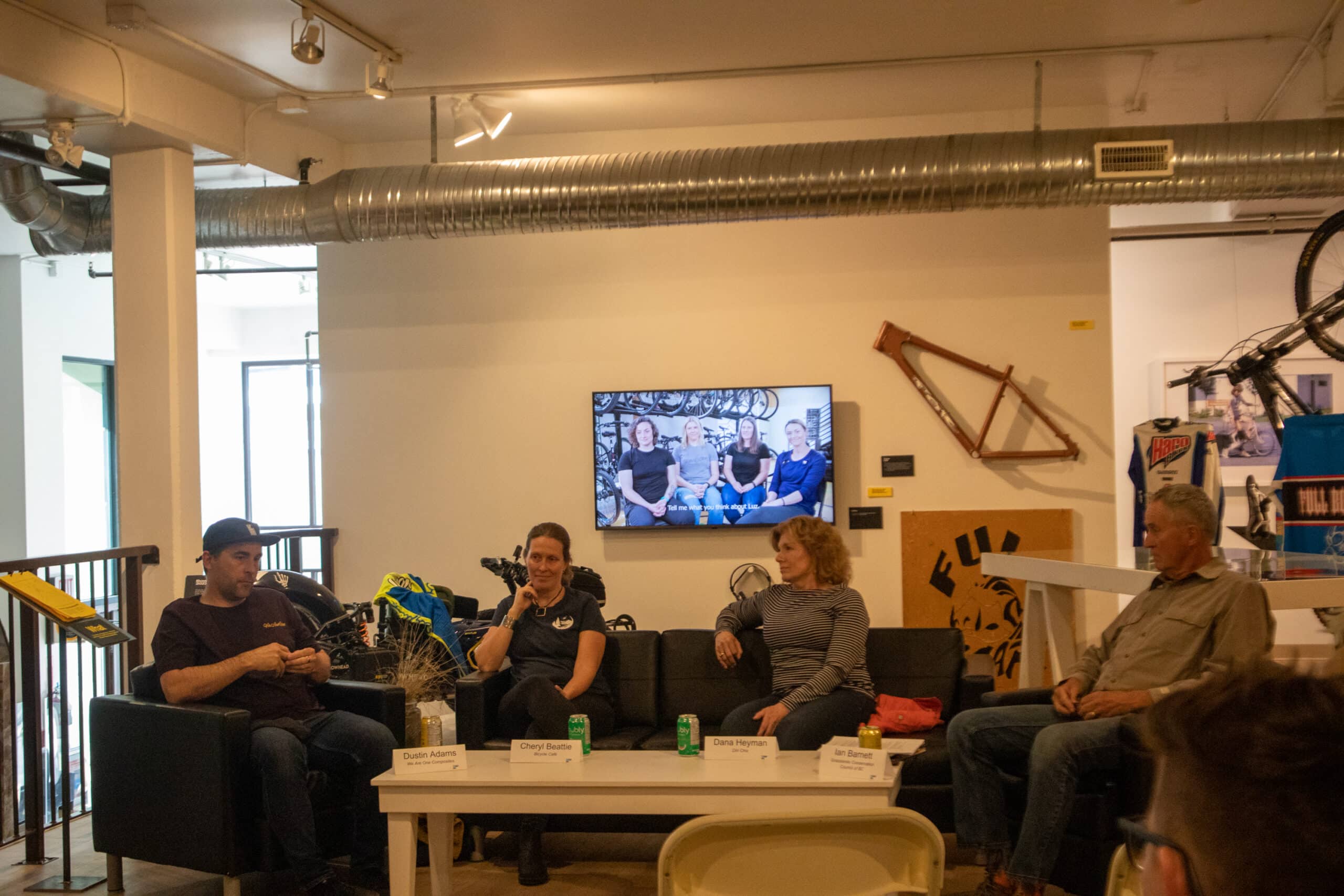Two men and two women sit discussing mountain bike culture.