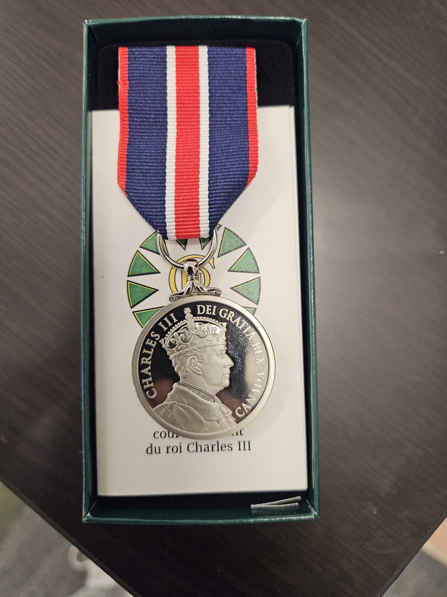 Sun Peaks mayor Al Raine accepts a King Charles III Coronation Medal